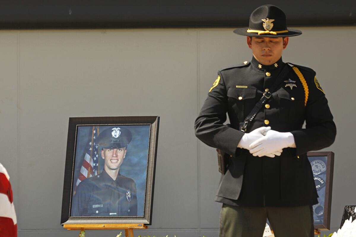A photo of LAPD Officer Houston Tipping is shown during his memorial.