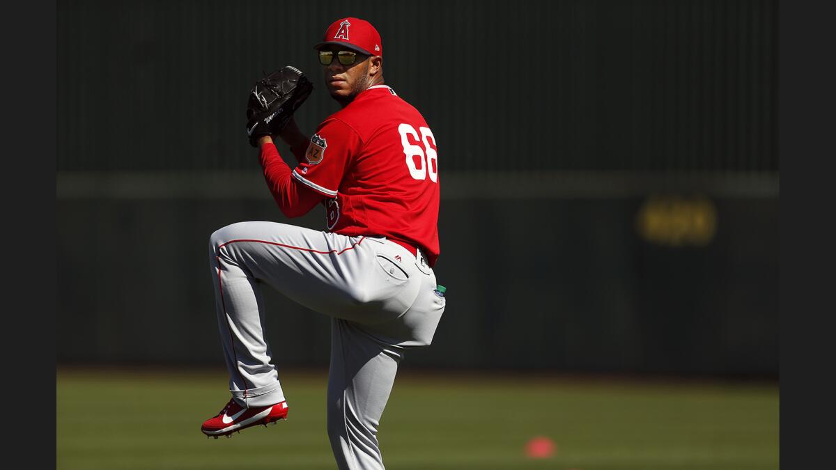 Angels relief pitcher J.C. Ramirez warms up during spring training on Feb. 24 at Tempe Diablo Stadium in Tempe, Ariz.