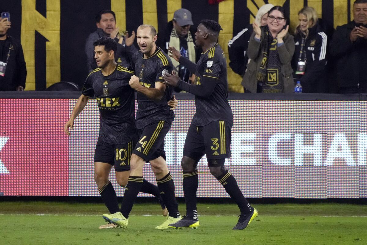 LAFC's Carlos Vela celebrates his goal against Alajuelense with Giorgio Chiellini and Jesús Murillo at BMO Stadium.