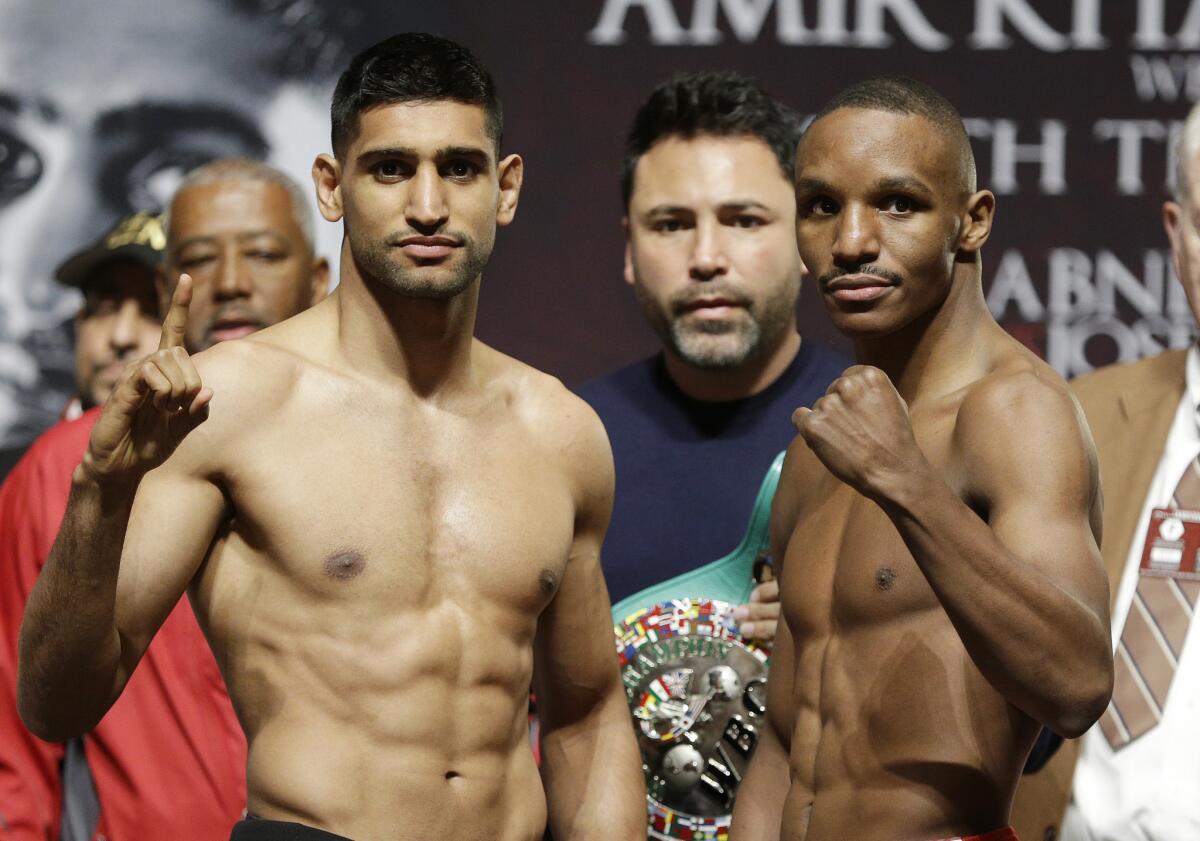 Amir Khan and Devon Alexander, right, pose after a weigh-in Friday ahead of their welterweight bout Saturday at the MGM Grand in Las Vegas.