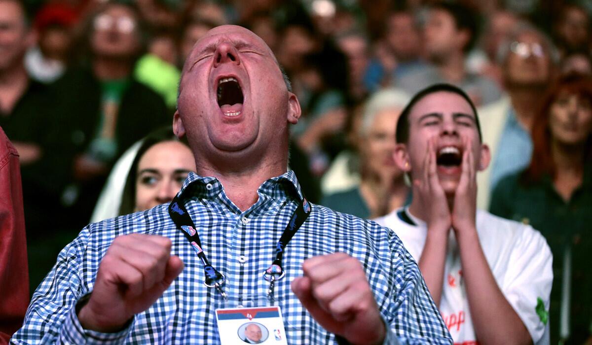 Clippers owner Steve Ballmer sings along with Fergie during the national anthem before the season opener against the Oklahoma City Thunder on Thursday night at Staples Center.