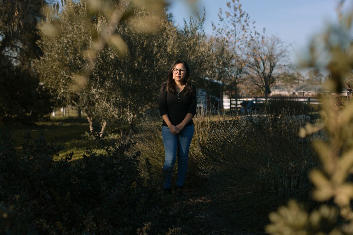Susana Lopez stands in her backyard