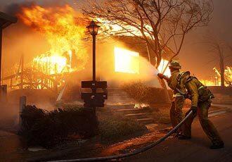 Firefighters pour water on a home in the Oakridge Mobile Home Park in Sylmar. Best of 2008 Photography >> Best of 2008 Main >>