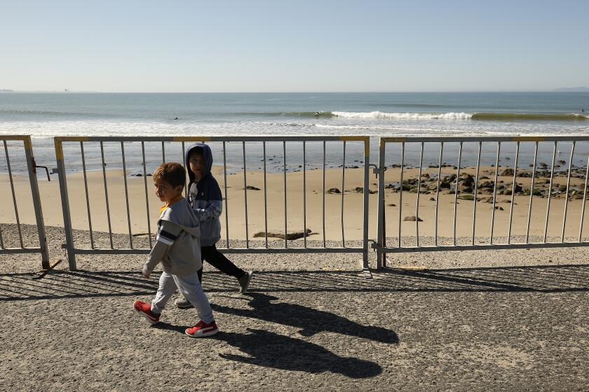 VENTURA, CA - APRIL 15: Children at surfers point at seaside park in Ventura as Ventura City has closed its parks, beach and pier on Wednesday morning as the sunshine and warm temperatures brought people to the beach despite warnings about the coronavirus Covid-19 pandemic. Ventura on Wednesday, April 15, 2020 in Ventura, CA. (Al Seib / Los Angeles Times)