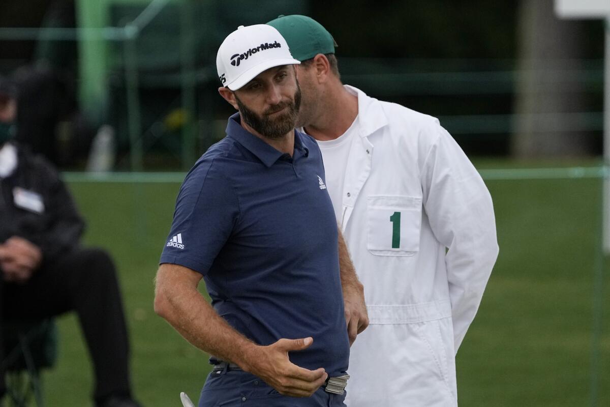 Dustin Johnson looks down after putting on the 18th green during the second round of the Masters.