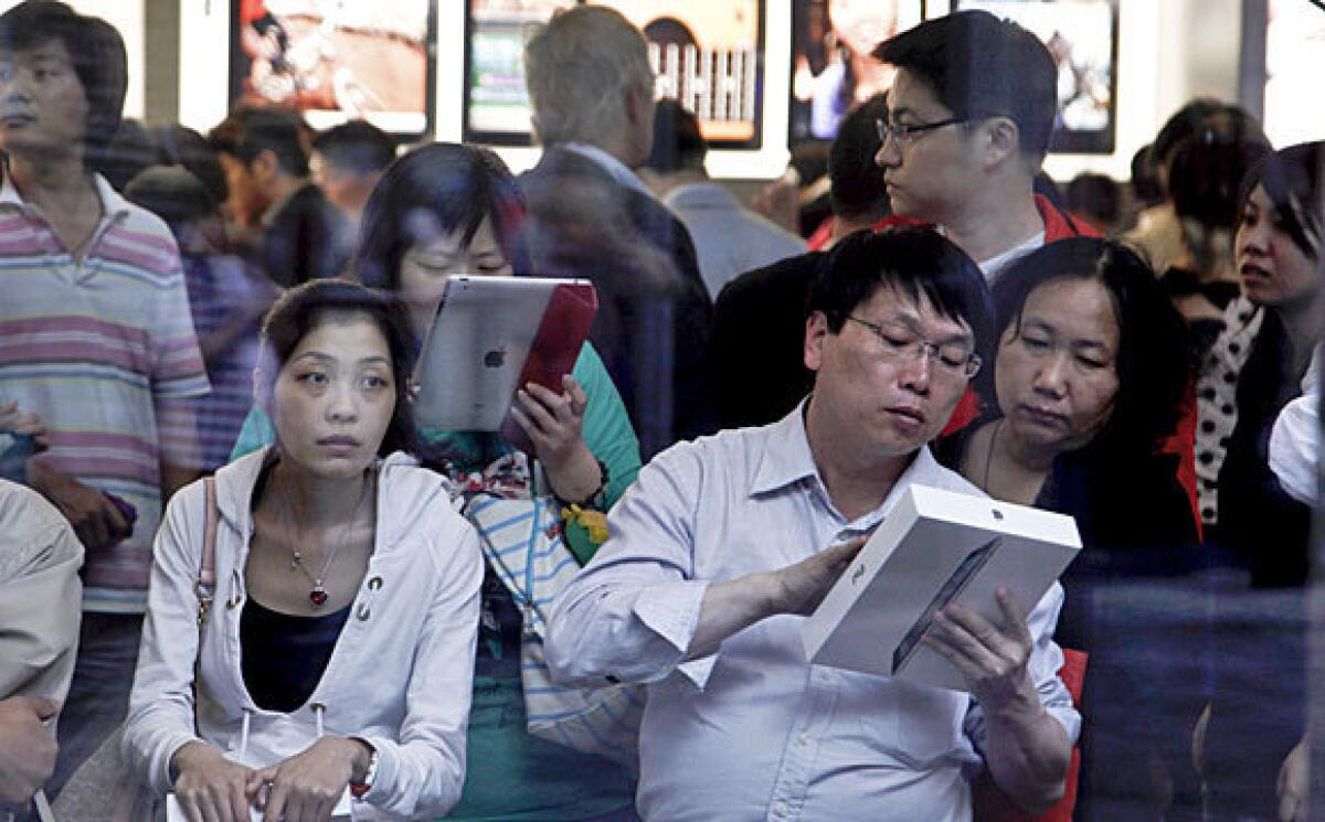 Chinese customers with iPads last year in an Apple store in Beijing.