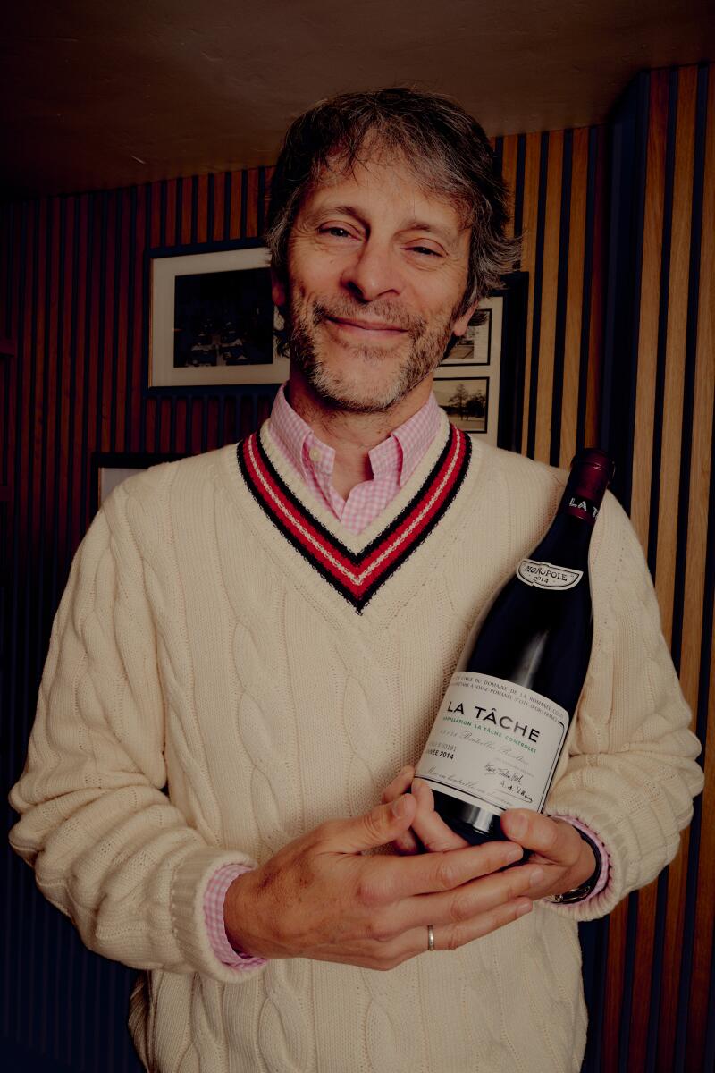 Sushi Note owner Dave Gibbs with a bottle of Burgundy wine.