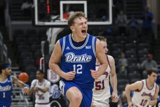 Drake guard Tucker DeVries (12) reacts after scoring a 3-point basket against Bradley.