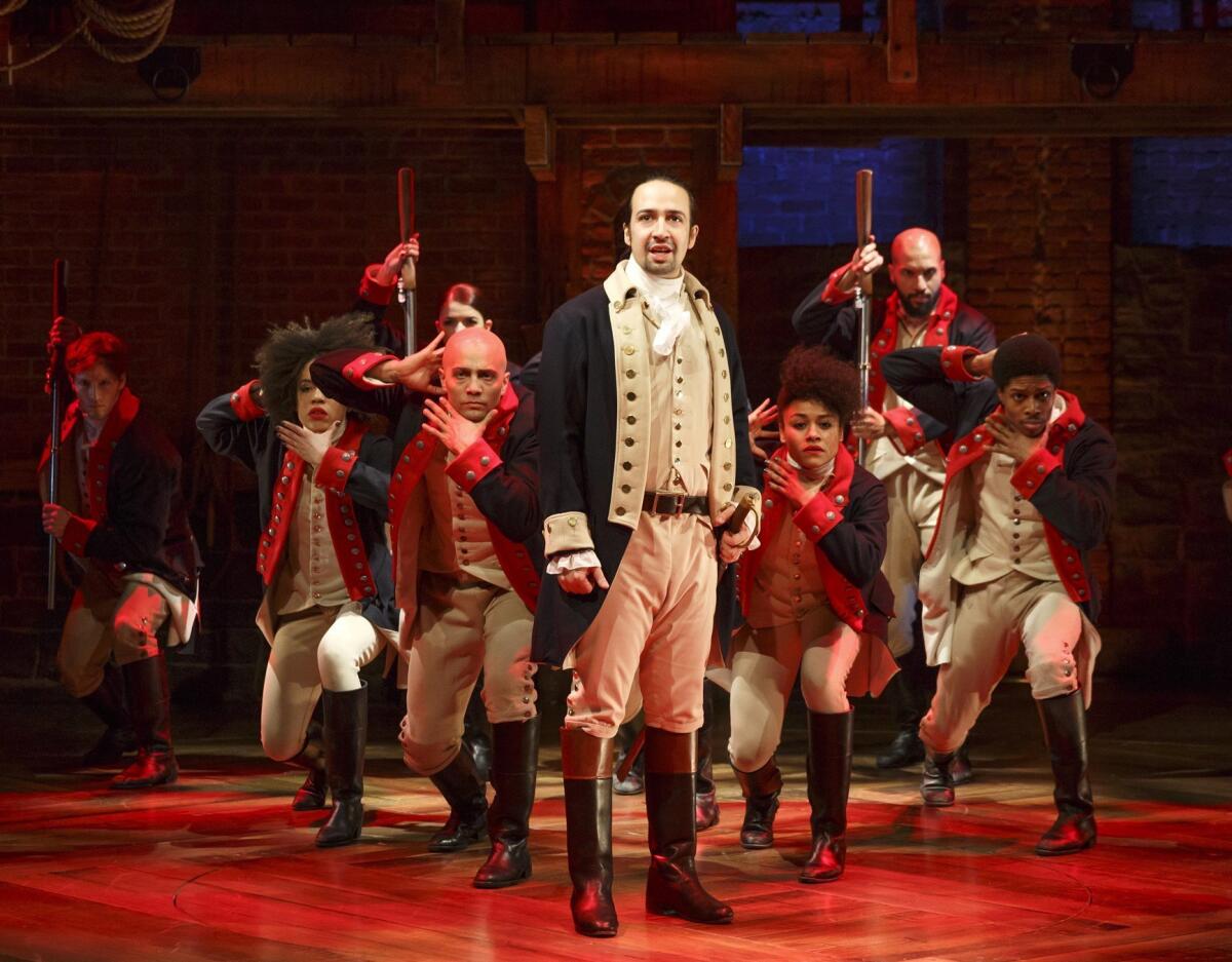 This image released by the Public Theater shows Lin-Manuel Miranda, center, with the cast of "Hamilton" during a performance in New York. The hip-hop show centers on the life of the nation's first secretary of the Treasury, Alexander Hamilton.