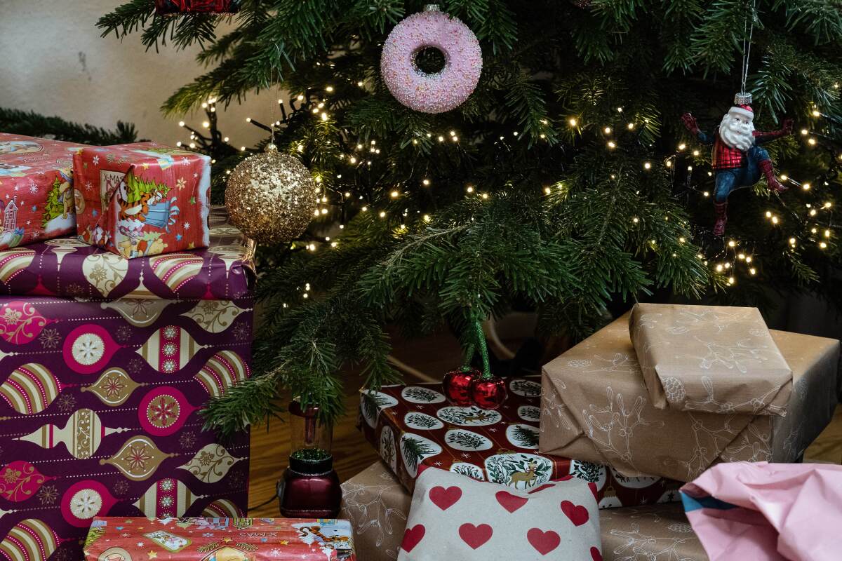 December 24, 2022, Lower Saxony, Gttingen: Wrapped gifts lie under a decorated Christmas tree.  In Germany, Christmas Eve has become the day for Christians to give gifts after dark.  Photo: Swen Pfrtner/dpa (Photo by Swen Pfrtner/image alliance via Getty Images)
