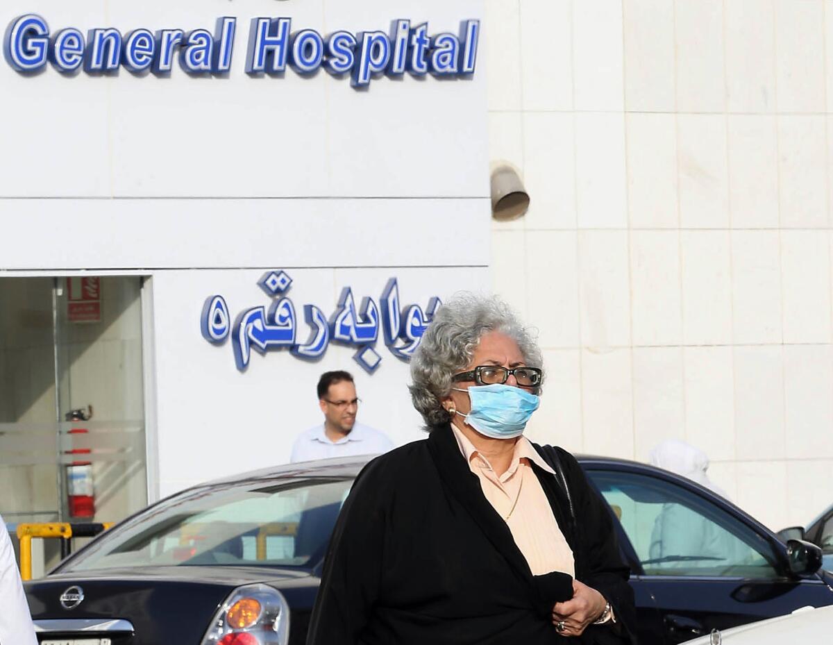 A woman wears a mask as she leaves a hospital Wednesday in the Red Sea coastal city of Jidda, Saudi Arabia.