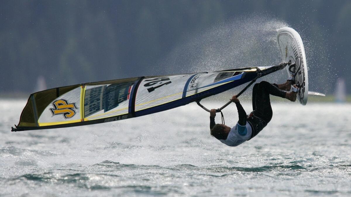 A windsurfer jumps over the water during the Freestyle Windsurfing World Championships on Lake Silvaplana in Switzerland in 2005.