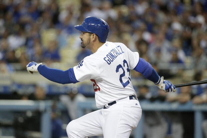 Dodgers first baseman Adrian Gonzalez breaks from the batter's box after connecting for a run-scoring double against the Rockies in the first inning Friday night.