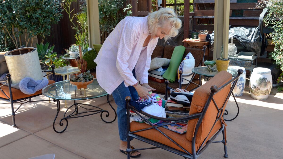 Buy Nothing Costa Mesa member Christine Bliss sorts through items for giving. 
