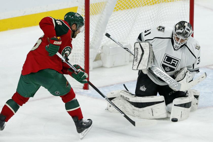 Kings goalie Peter Budaj, right, stops a shot by Minnesota Wild's Jason Zucker during the third period Tuesday.