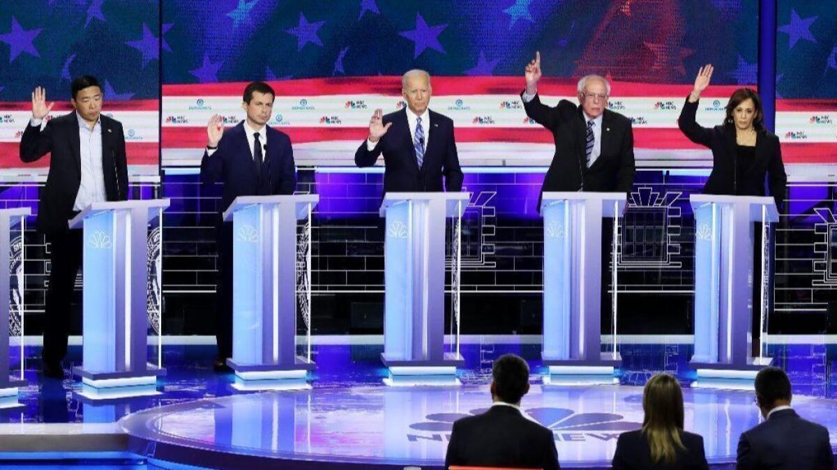 From left, Andrew Yang, Pete Buttigieg, Joe Biden, Bernie Sanders and Kamala Harris respond to a moderator's question at Thursday's Democratic presidential debate in Miami.