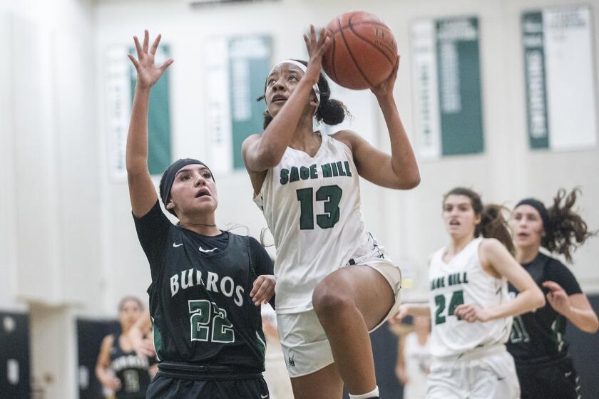 Sage Hill's Zoie Lamkin goes up for a shot against Ridgecrest Burroughs' Lysette Sepulveda during a CIF Southern Section Division 3AA quarterfinal game on Wednesday, June 2.