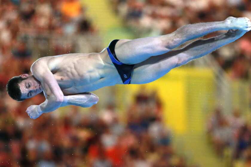 David Boudia of the United States spins through the air in the men's 10m platform diving competition. He won the gold medal.