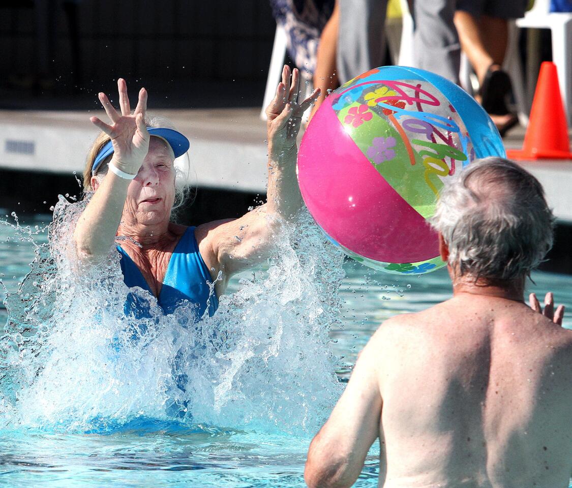 Mary Bries, of Burbank, jumps out of the pool to hit a beach ball tossed by her husband Charlie at the Rock-A-Hula Pool Party at Verdugo Aquatic Facility in Burbank on Thursday, August 27, 2015. The free party was open to adults 55 and over for food, swimming, and dancing to a live band.