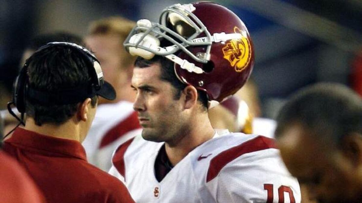 USC quarterback John David Booty is consoled after throwing an interception against UCLA late in the fourth quarter at the Rose Bowl on Dec. 2, 2006.