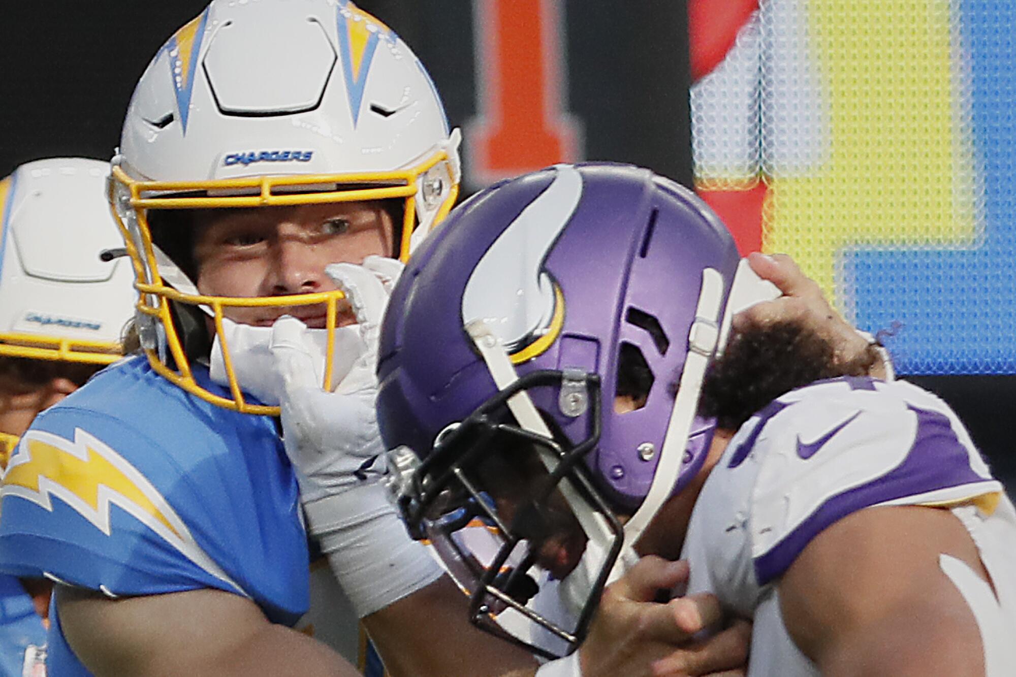 Chargers quarterback Justin Herbert tackles Minnesota's Eric Kendricks.