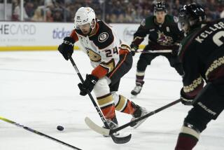 Anaheim Ducks' Bo Groulx (24) controls the puck in front of Arizona Coyotes' Clayton Keller.
