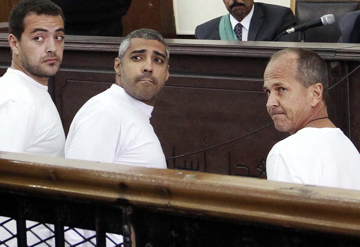Peter Greste, right, is shown with Al Jazeera colleagues Baher Mohamed, far left, and Mohamed Fahmy in court on March 31, 2014, during their trial on terrorism-related charges in Cairo.