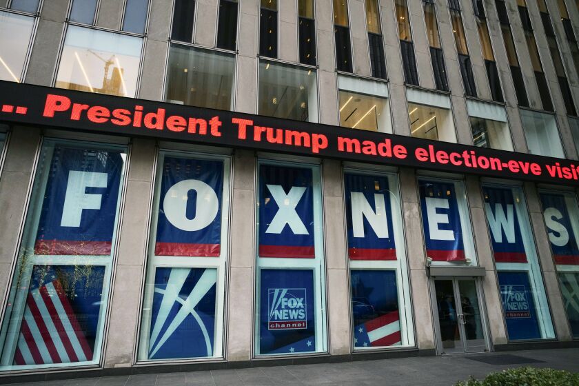 FILE - A headline about President Donald Trump is displayed outside Fox News studios in New York on Nov. 28, 2018. Lawyers for Fox News and a voting machine company on Wednesday, March 22, 2023, tangled over the high bar to prove defamation in a $1.6 billion lawsuit that has embarrassed the conservative network over its airing of false claims related to the 2020 presidential election. (AP Photo/Mark Lennihan, File)