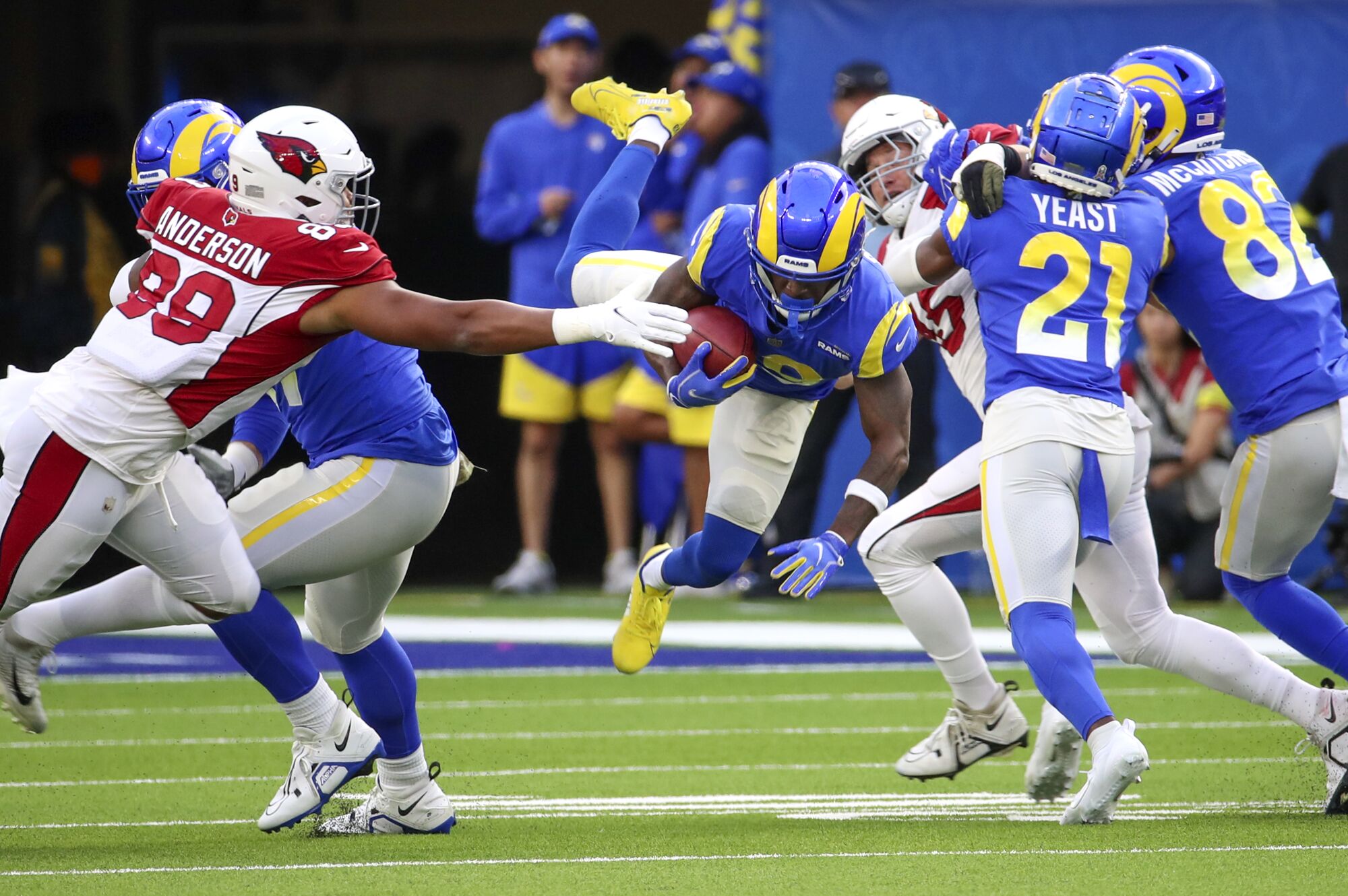 Rams wide receiver Brandon Powell, center, leaps through the tackle by Cardinals defensive end J.J. Watt.