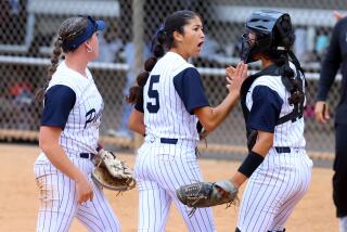 Pacifica High pitcher Brynne Nally (5) is congratulated by catcher Catherine Benitez after retiring the side.