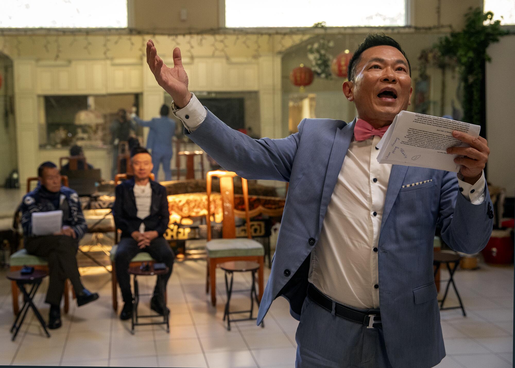 Kevin Yang makes a wide gesture while rehearsing a scene