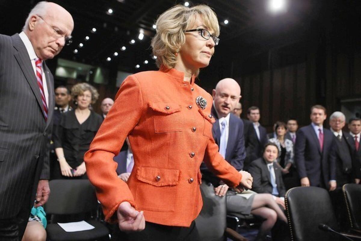 Former Rep. Gabrielle Giffords and husband Mark Kelly, right, arrive for the Senate Judiciary Committee hearing on gun control, where both testifed.