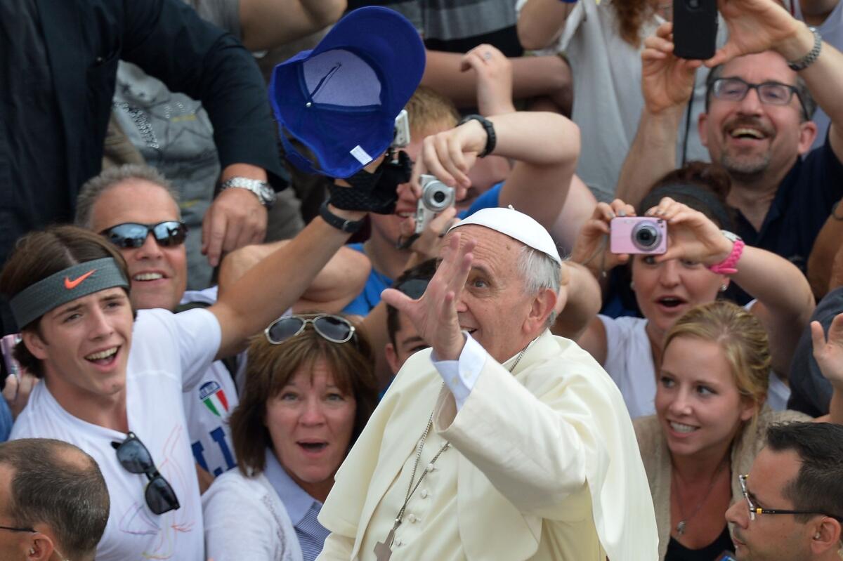 Pope Francis catches a cap thrown by a pilgrim during his general audience at St. Peter's Square on Wednesday.
