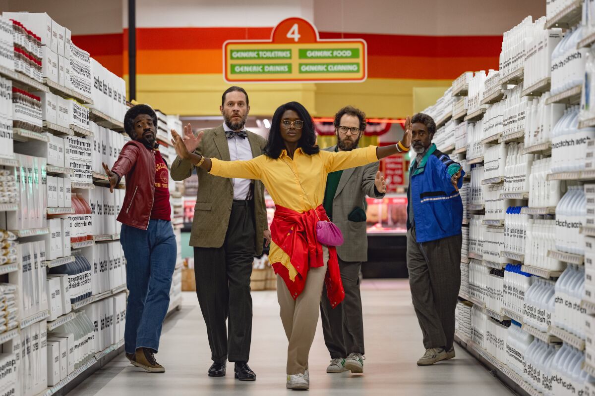 Four men and a woman dance in a supermarket in a scene from "White noise."