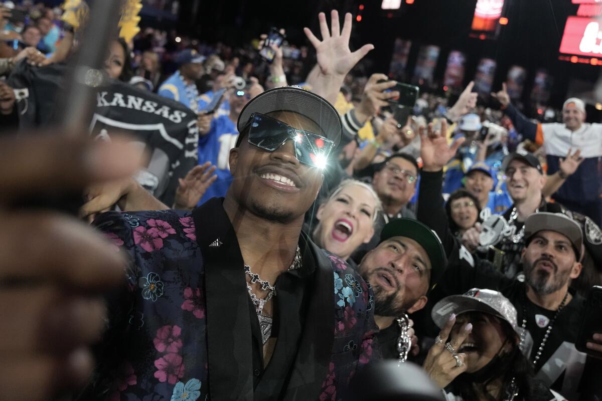 Texas Tech defensive lineman Tyree Wilson takes a selfie with fans after being chosen by the Las Vegas Raiders.