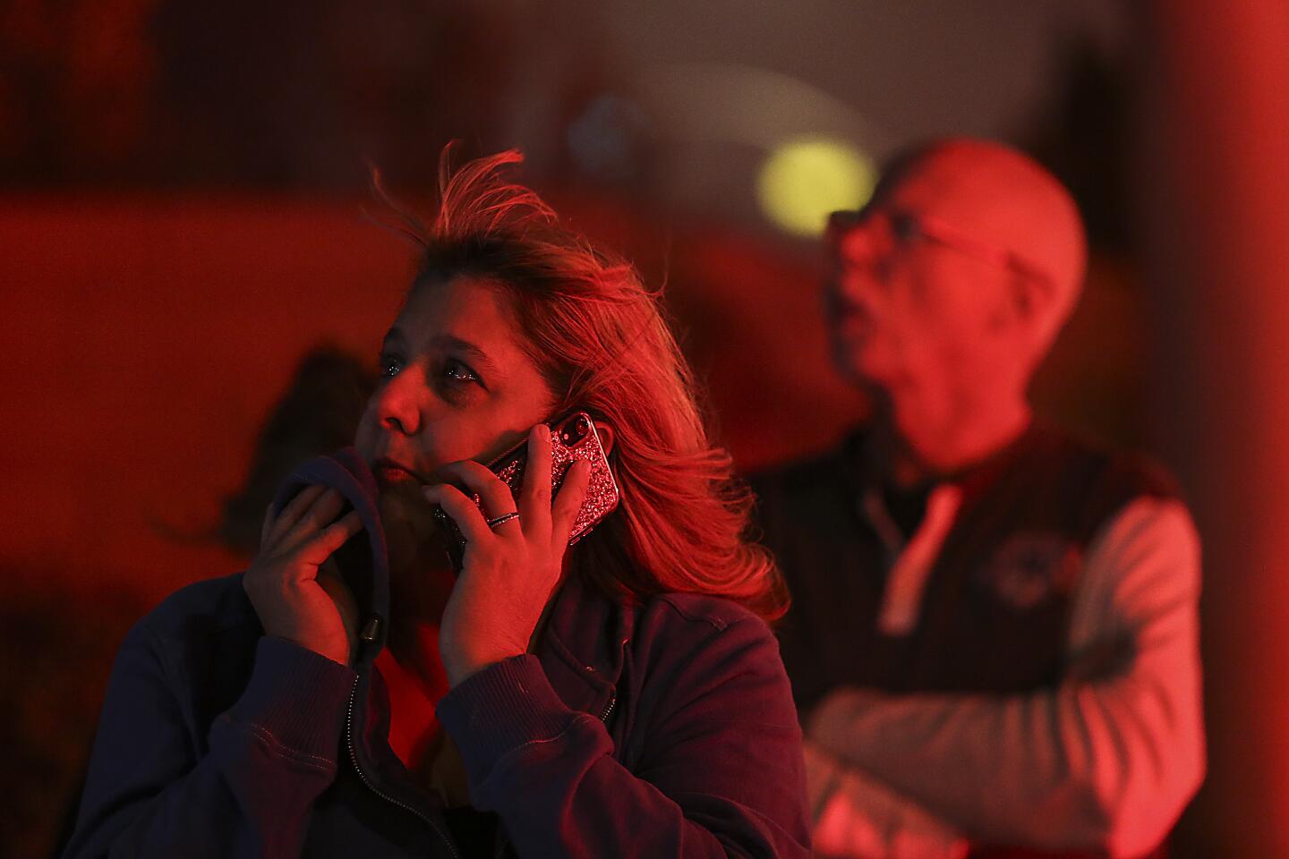 Dyanna Andreou, a resident of the Coyote Hills neighborhood, watches firefighters battle the Castlewood fire.