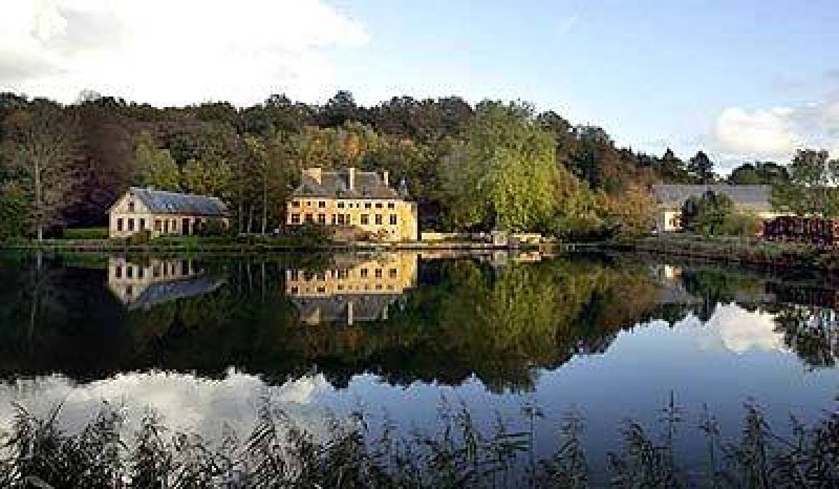 The Semois River pools in front of a chateau near the Abbey of Orval in southern Belgium.