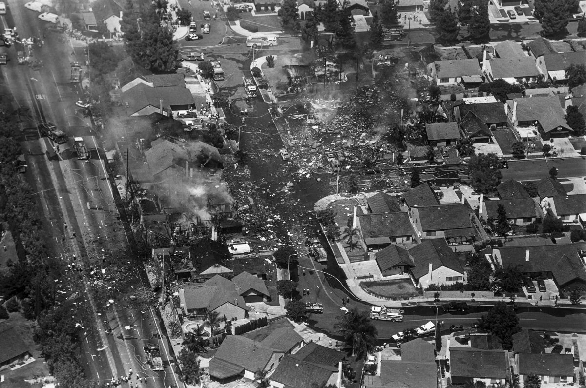 Aug. 31, 1986: The smoldering ruins of homes mark the area of Cerritos where an Aeromexico jetliner fell to the ground.