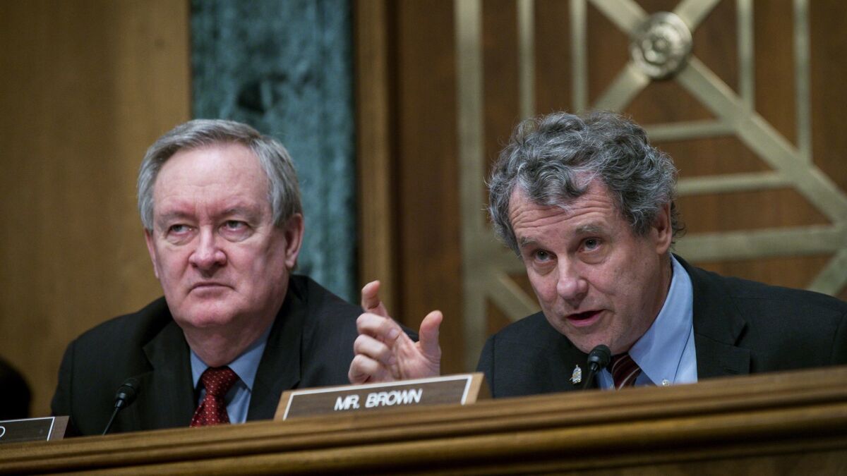 Senate Banking Committee Chairman Mike Crapo (R-Idaho), left, the lead sponsor of a bank deregulation bill, and Sherrod Brown (D-Ohio), who is leading opposition to the legislation, participate in a hearing on Jan. 30.
