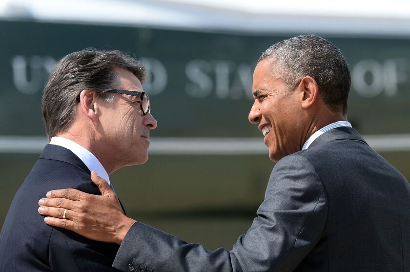 Texas Gov. Rick Perry meets President Obama upon his arrival in Dallas.