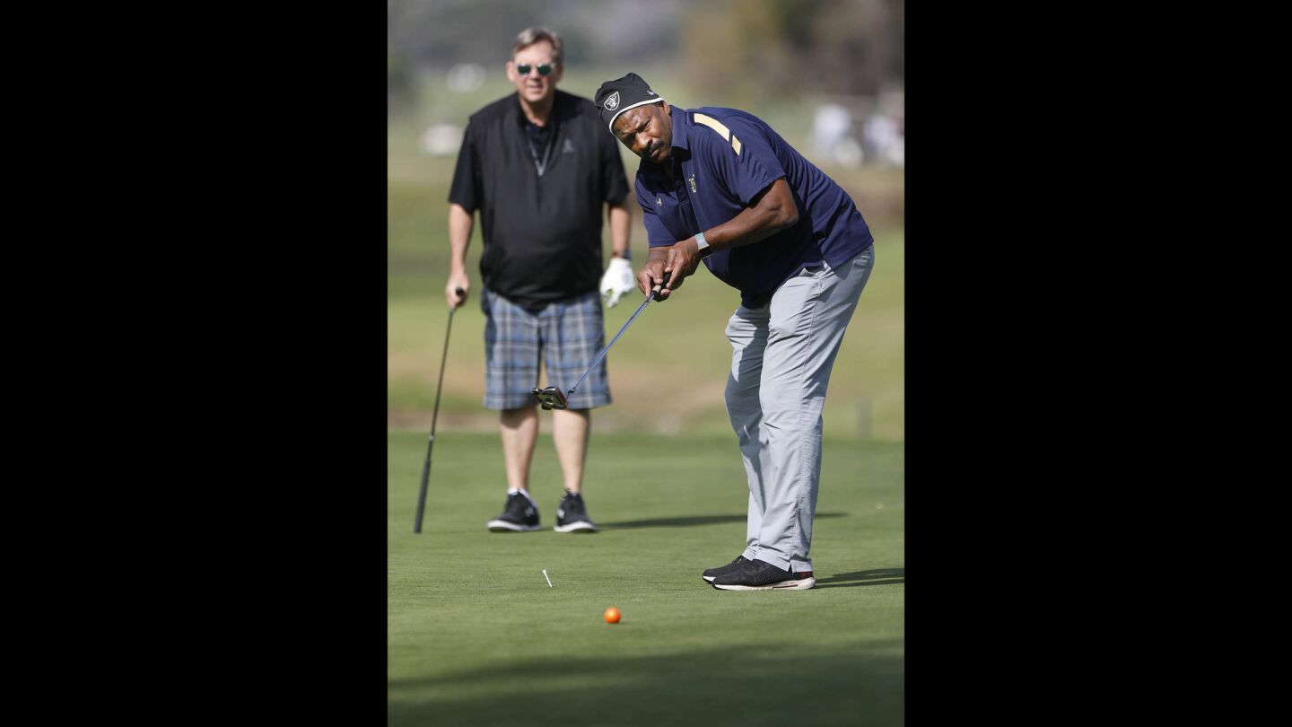 Napoleon McCallum who played football for the U.S.Naval Academy and Oakland Raiders, putts on the second hole green during the Navy-Notre Dame Golf Tournament at the Riverwalk Golf Club in Mission Valley in advance of the football game between the two schools to be held at SDCCU Stadium, Saturday.