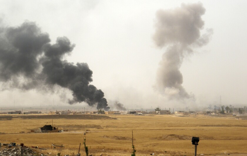Smoke rises during a military operation launched by Kurdish troops in Iraq's northern Kirkuk province on Sept. 30, 2015. A U.S. service member was killed Thursday in a hostage rescue operation involving American and Iraqi commandos.