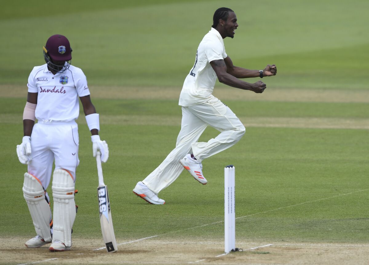 England's Jofra Archer, right, celebrates the dismissal of West Indies' Shamarh Brooks, left, during the fifth day of the first cricket Test match between England and West Indies, at the Ageas Bowl in Southampton, England, Sunday, July 12, 2020. (Mike Hewitt/Pool via AP)