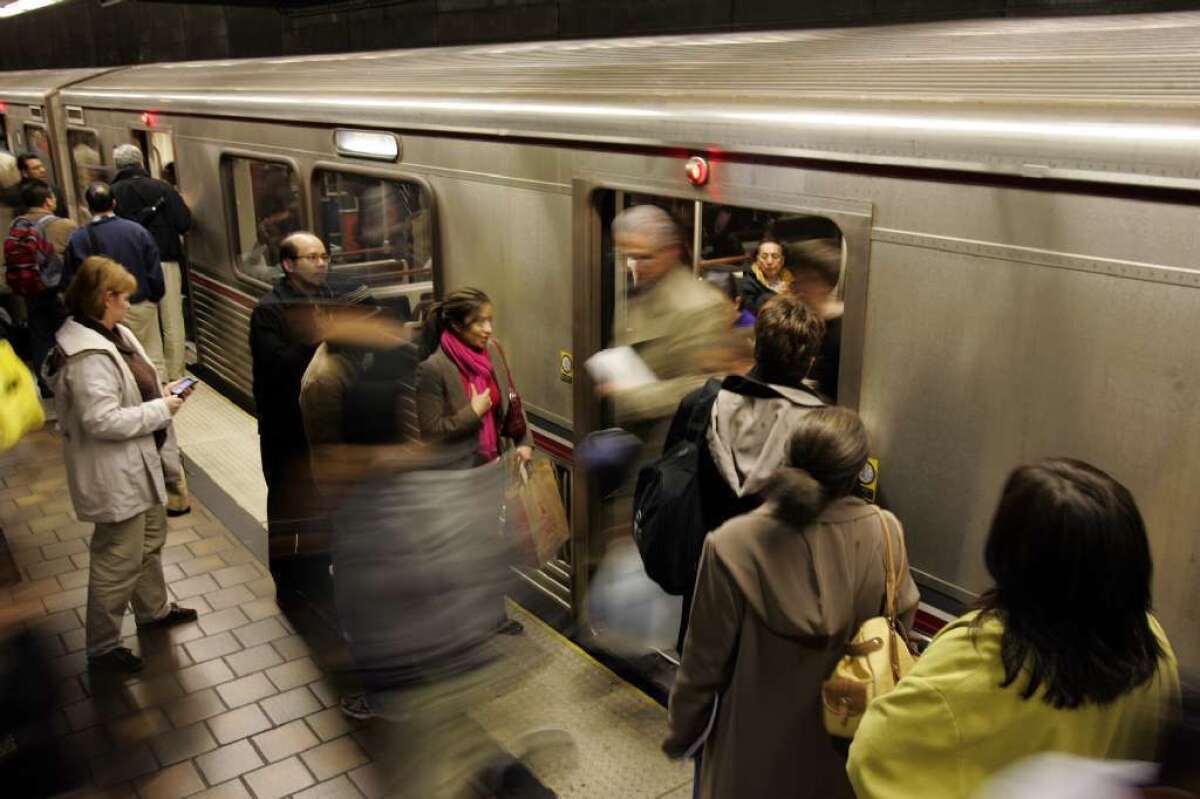 Commuters board the Red Line at 7th Street.