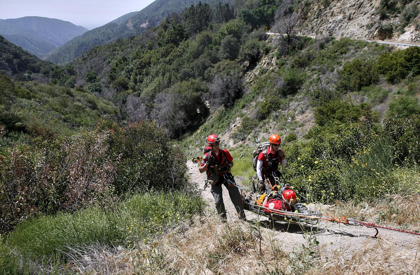 Members of the Altadena Mountain Rescue Team bring up a "victim" during multi-agency "over-the-side" high angle, technical rescue exercise on Angeles Crest Highway in the Angeles National Forest on Friday, April 26, 2013. About 100 personnel from different local agencies participated, including some from the L.A. Co. Sheriff Montrose Search & Rescue Team, Altadena MRT, L.A. County Fire Depts. from La Canada Flintridge and Pico Rivera along with Air Rescue 5, and the U.S. Forest Service.