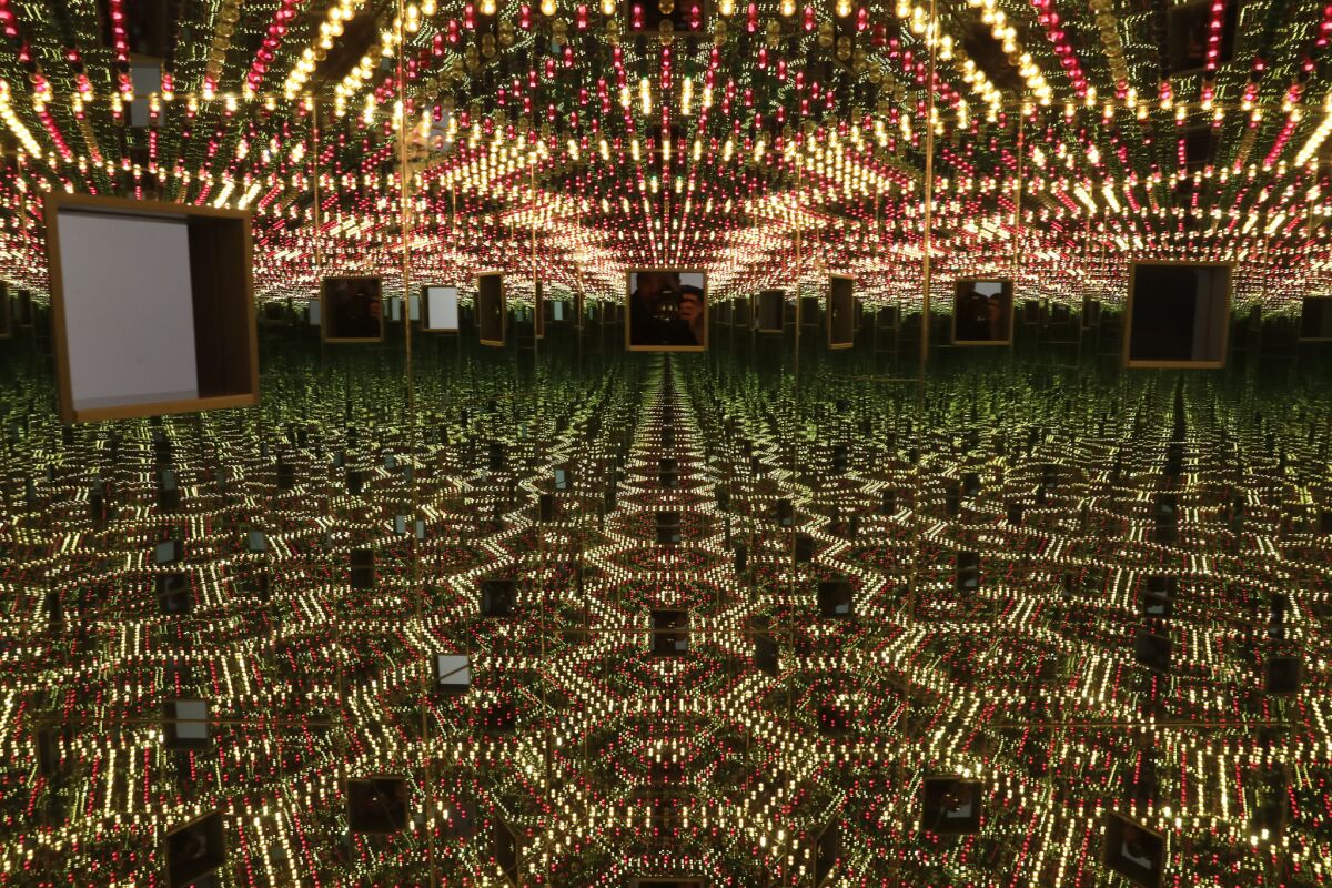 Kusama's "Infinity Mirrored Room — Love Forever," with twin peep holes to look at the changing lights inside.