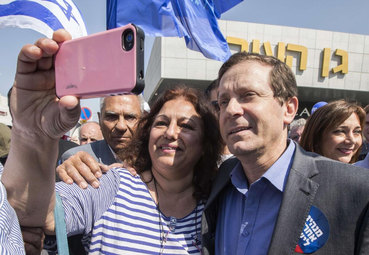 A supporter takes a selfie with Isaac Herzog, Israeli Labor Party leader and co-leader of the Zionist Union alliance for the upcoming general election, in Ashdod on Friday.