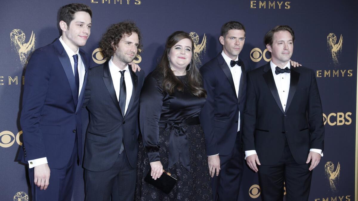 Actress Aidy Bryant, center, with Pete Davidson, far left, Kyle Mooney, Mikey Day, right, and Beck Bennett, of "Saturday Night Live."