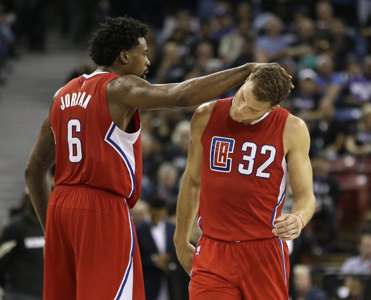 Clippers center DeAndre Jordan, left, gives forward Blake Griffin a pat after he scored late in the fourth quarter against the Kings.
