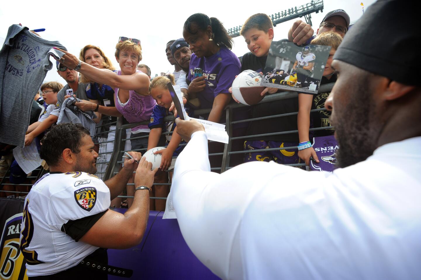 Ravens Haloti Ngata, left, and Ray Lewis sign autographs for fans after practice at M&T Bank Stadium in 2011. It was the only open practice that year after a four-month lockout.